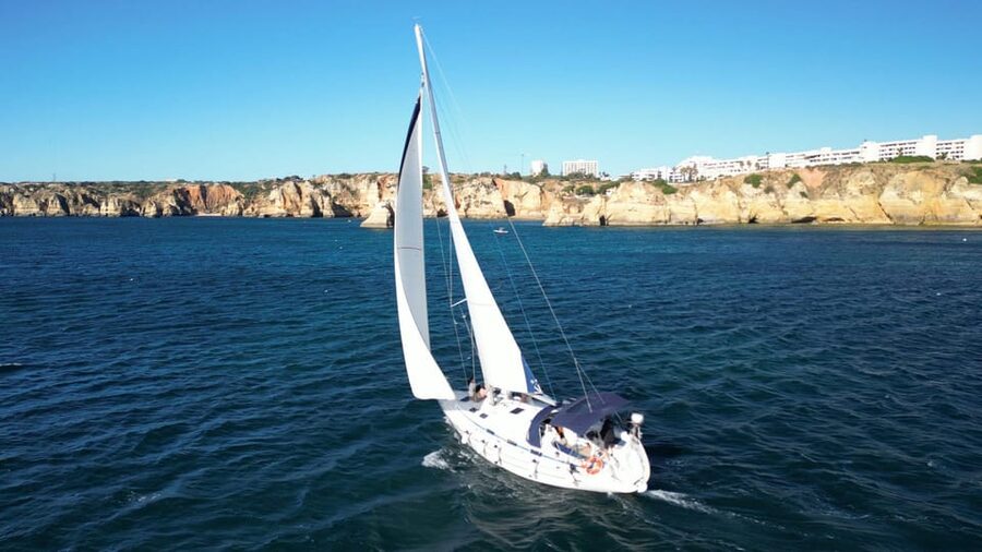 Golden Hour on Elegant Yacht: Sunset Tour in Lagos, Algarve - Following the Cliffs Toward Meia Praia