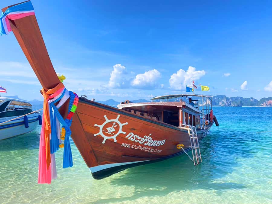 Krabi: Luxury Boat 7 Island Sunset With BBQ & Plankton Tour - Boarding a vintage-style boat from the private pier