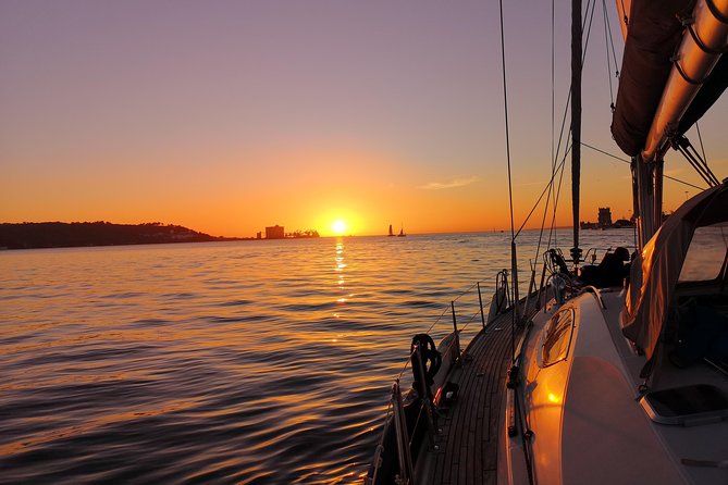 Lisbon Sunset Sailing Tour on Luxury Sailing Yacht with 2 Drinks - Under the 25th of April Bridge