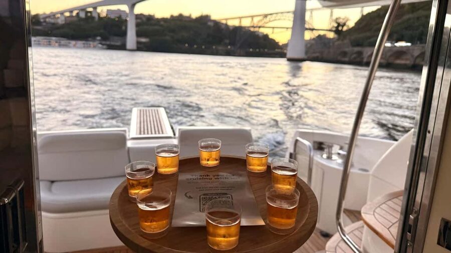Porto: Luxury 6 Bridges Yacht Cruise with Wine & Snacks - Under Dom Luís Bridge beside Ribeira
