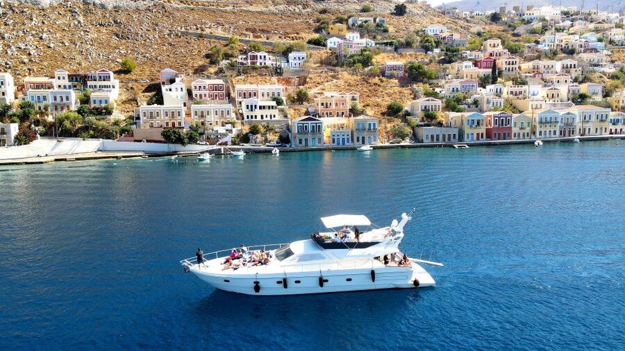 Rhodes: Symi Yacht Tour with Unlimited Drinks and Transfer - Arriving at Symi’s colorful harbor