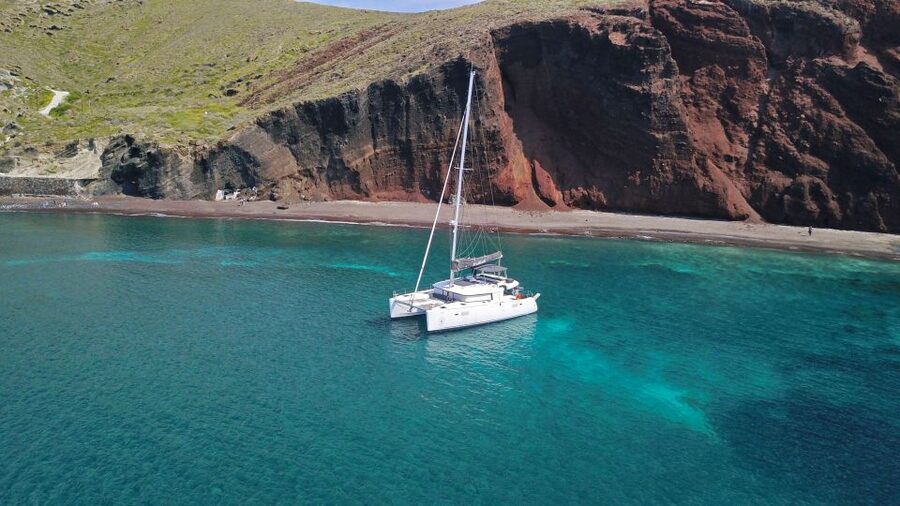 Santorini: Caldera Luxury Catamaran Cruise w/ Meal & Drinks - Akrotiri Lighthouse and the volcanic coast