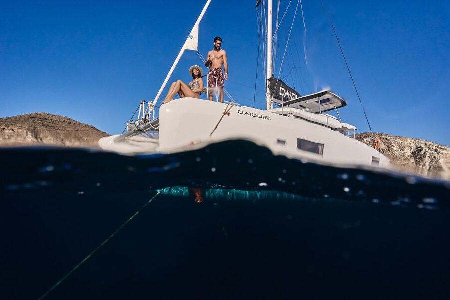 Santorini: Day Luxury Catamaran Cruise with Meal & Drinks - Black lava and Santorini’s volcanic islets