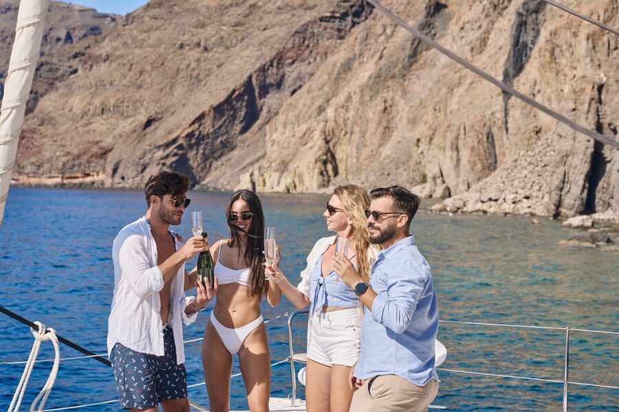 Santorini: Day Luxury Catamaran Cruise with Meal & Drinks - Crew service and the small risk of uneven guiding
