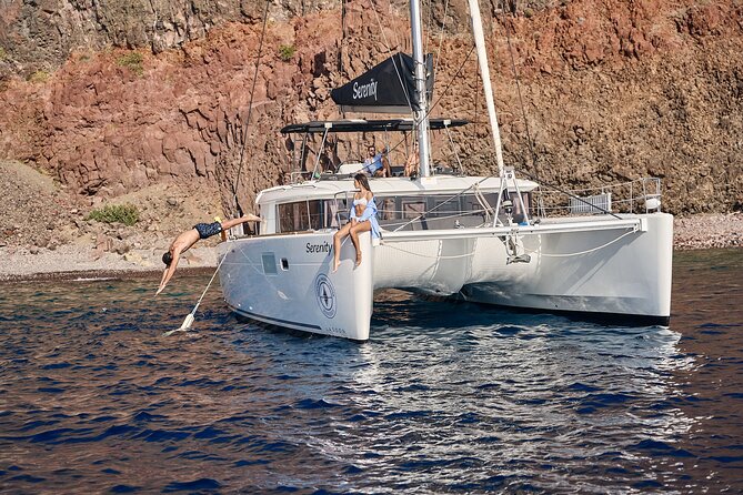 Santorini: Luxury Catamaran Cruise with Fresh Fish BBQ & Drinks - White Beach and the changing volcanic coast