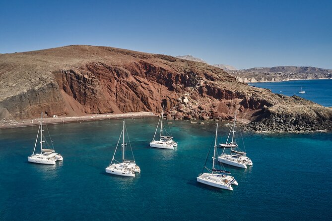 Santorini: Luxury Catamaran Cruise with Fresh Fish BBQ & Drinks - Red Beach: volcanic color from the water