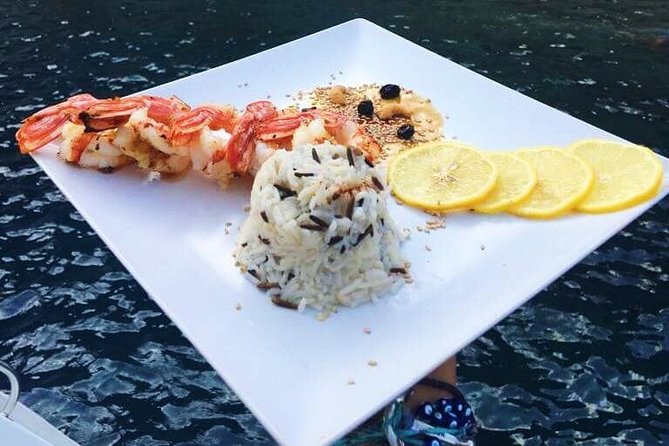 Santorini Luxury Catamaran Sunset Cruise with BBQ, Drink and Transfer - Red Beach from the water